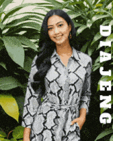 a woman in a snake print dress is standing in front of some plants and the name diajeng is on the bottom