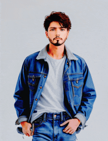 a man with a beard wearing a blue denim jacket