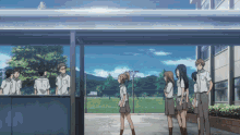 a group of people standing in front of a building with a blue sky behind them