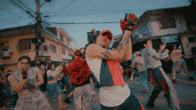 a group of people are dancing in a street with the words sweettealeaves visible in the corner