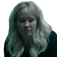 a woman with blonde hair is wearing a black shirt and a gold necklace