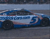 a hendrick cars.com race car is driving down the track