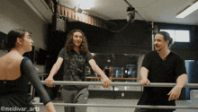 a man wearing a shirt that says led zeppelin is standing next to two other men