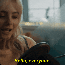 a woman is looking at herself in a mirror and the words hello everyone are above her