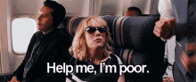 a woman wearing sunglasses on an airplane says help me i 'm poor .
