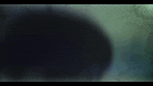a close up of a person 's face with glowing eyes and the letter c on them