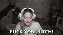 a woman wearing headphones is talking into a microphone and saying `` fuck you , bitch ! ''
