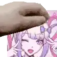 a close up of a hand holding a picture of a girl with purple hair .