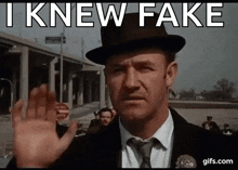 a man in a hat says i knew fake while waving