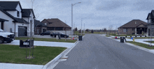 a white truck is parked on the side of a street in a residential area