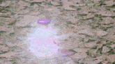 a bottle with a purple cap is glowing in the dark