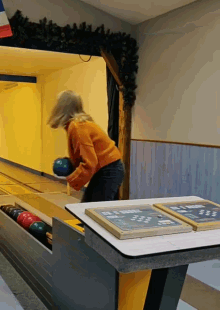 a bowling alley with a chalkboard that says " bowl " on it