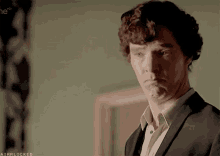 a man in a suit is making a funny face with the hashtag airrlocked