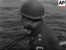 a black and white photo of two soldiers in the water with the letters ap on the bottom