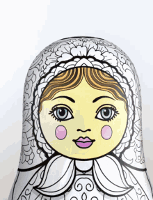 a close up of a russian doll with a yellow face and blue eyes