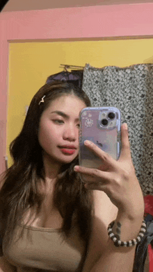 a woman is taking a picture of herself in the mirror with her phone