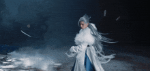 a woman with long white hair is wearing a white fur coat