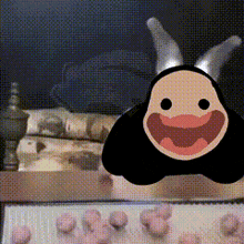 a cartoon character with horns and a smile on its face