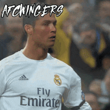 a soccer player wears a fly emirates jersey