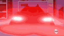 a red car is in a dark room with a hub logo in the corner