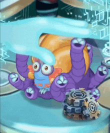 a purple and orange cartoon character is being held by a hand