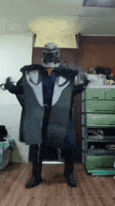 a man in a costume is standing in a room with a green dresser .