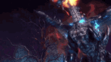 a dragon with flames coming out of its mouth is standing in the dark .