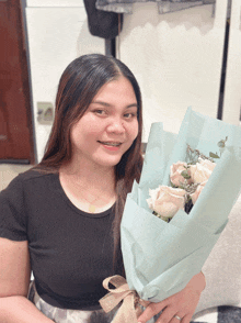 a woman is holding a bouquet of flowers in her hands