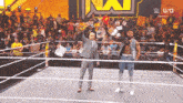two men in a wrestling ring with a crowd behind them and a sign that says usa