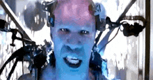 a close up of a man 's face with a lot of wires coming out of his head .