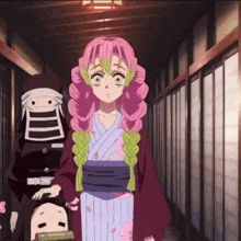 a girl with pink hair and green braids is standing in a hallway