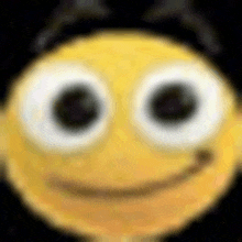 a close up of a yellow smiley face with big eyes and a hat .