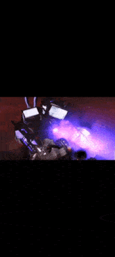 a purple light is coming out of a computer monitor