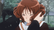a girl covering her face with her hand while crying