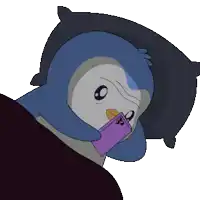 a penguin is laying on a pillow holding a purple phone