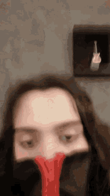 a woman covering her face with a red object