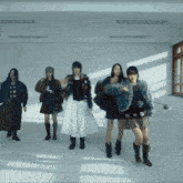 a group of women dancing in a room with a window