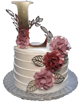 a white cake with flowers and leaves and a letter l on top