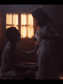 a man and a woman are having sex in a dark room