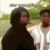a couple of men standing next to each other with the words star connexion written above them