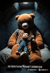 a teddy bear is holding a baby in a dark room with the words 0670entaxim planet debrecen below it