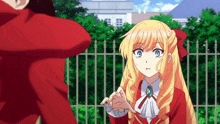 a girl with blonde hair and blue eyes holds someone 's hand