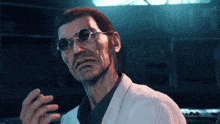 a man wearing glasses and a lab coat is looking at the camera