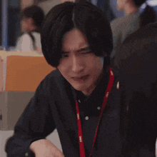 a man with his hands folded in front of his face .