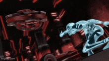 a man in a futuristic suit is kneeling down in front of a red object .