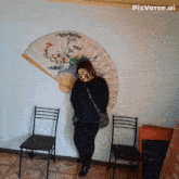 a woman standing in front of a large fan with pixverse.ai written on the bottom right