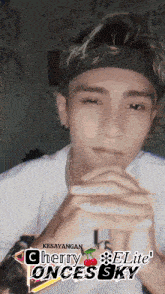 a man wearing a headband with the words kesayangan cherry elite once sky on the bottom