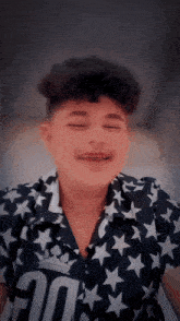 a boy wearing a shirt with the number 20 on it is making a funny face