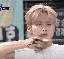 a man is holding a bow and arrow in his hand .