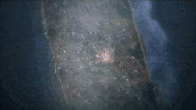 a blurred image of a light coming out of a hole in the ground